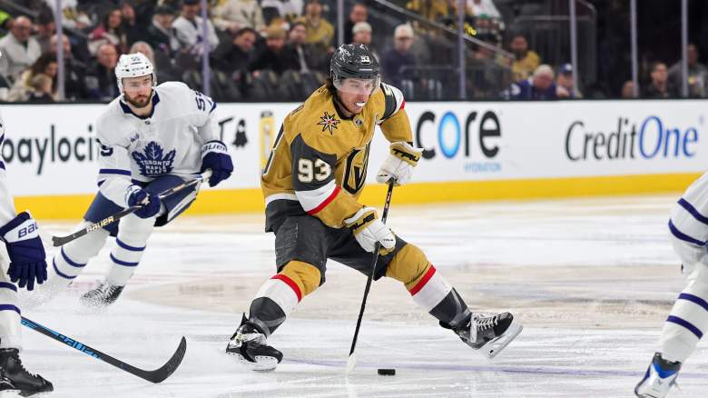 Mitch Marner #93 of the Vegas Golden Knights skates with the puck against Philippe Myers #51 and Auston Matthews #34 of the Toronto Maple Leafs in the second period of their game at T-Mobile Arena on January 15, 2026 in Las Vegas, Nevada.