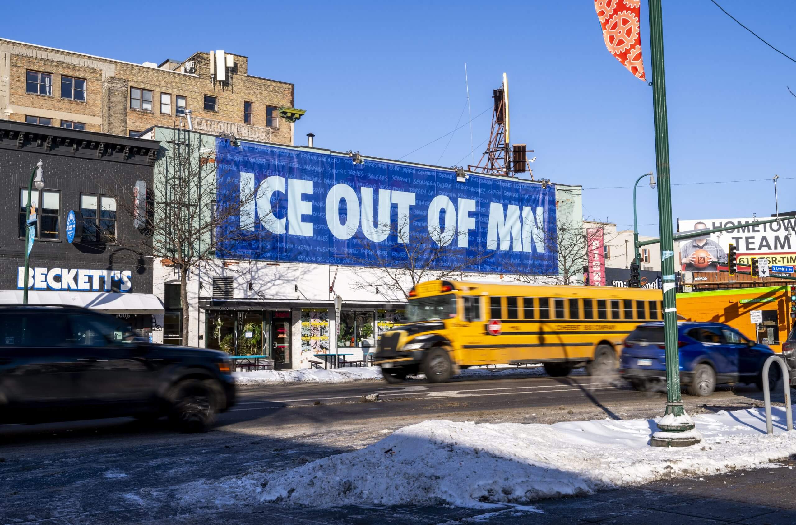 A banner reading "ICE OUT OF MN" hangs on the side of Wrecktangle Pizza on in Minneapolis in February, 2026.