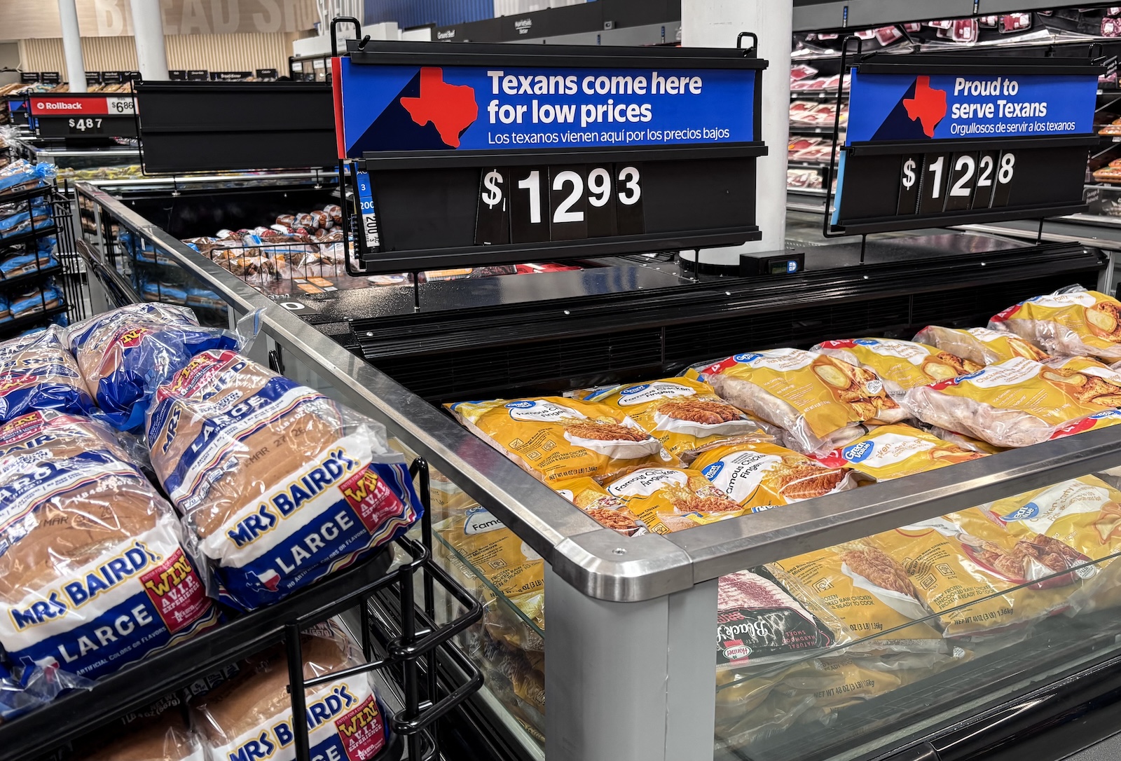 packages of chicken fingers at a supermarket in Texas, with a sign "Texans come here for low prices" above the food
