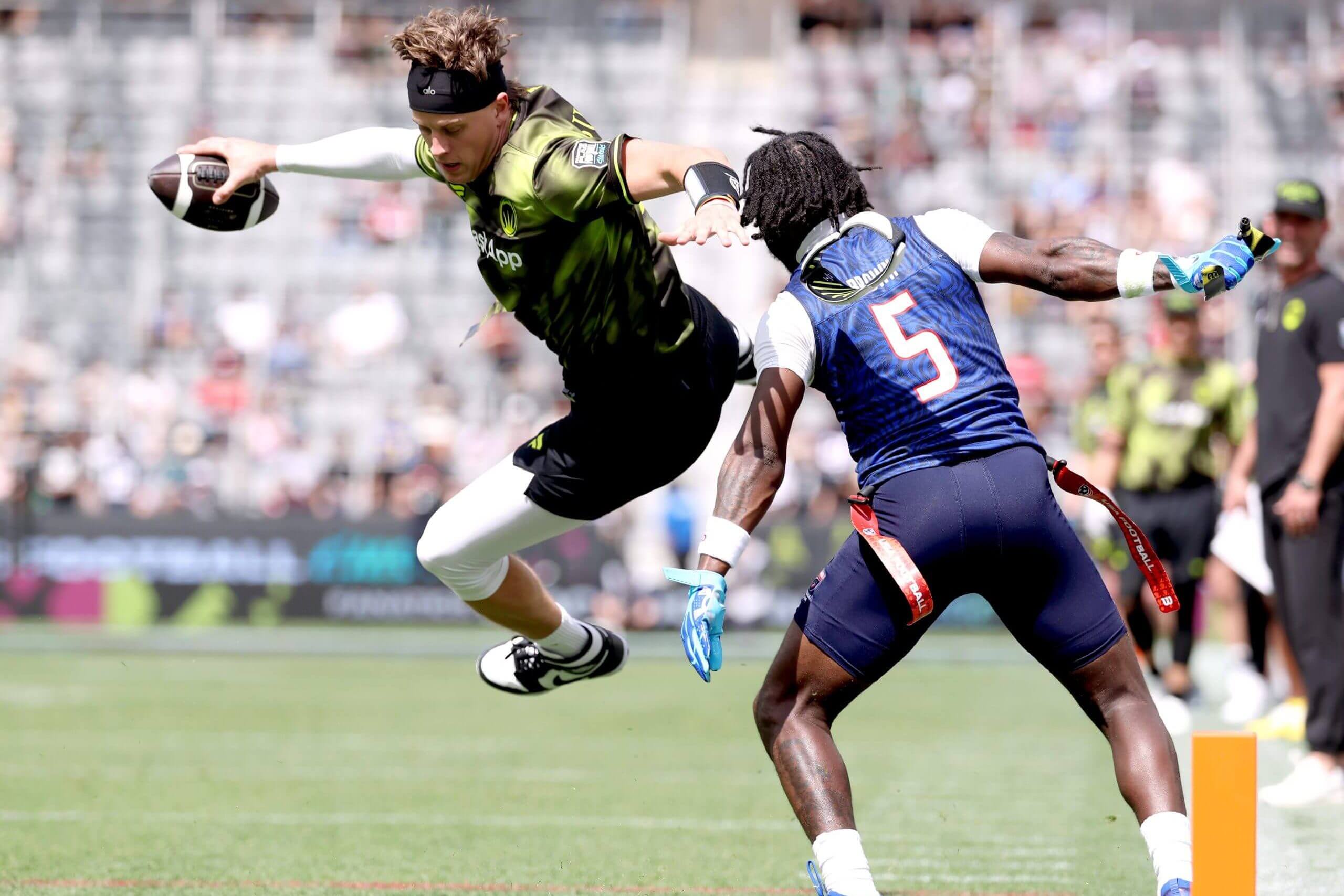 : Joe Burrow #9 of the Wildcats FFC is defended by Aamir Brown #5 of the US Men's Flag Football Team during the Fanatics Flag Football Classic at BMO Stadium on March 21, 2026 in Los Angeles, California.