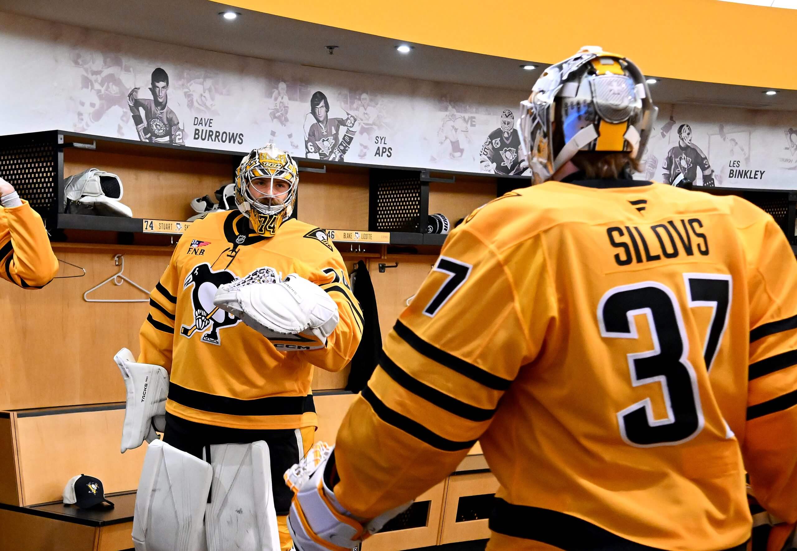 Pittsburgh goalies Stuart Skinner and Arturs Silovs chat in the locker room.