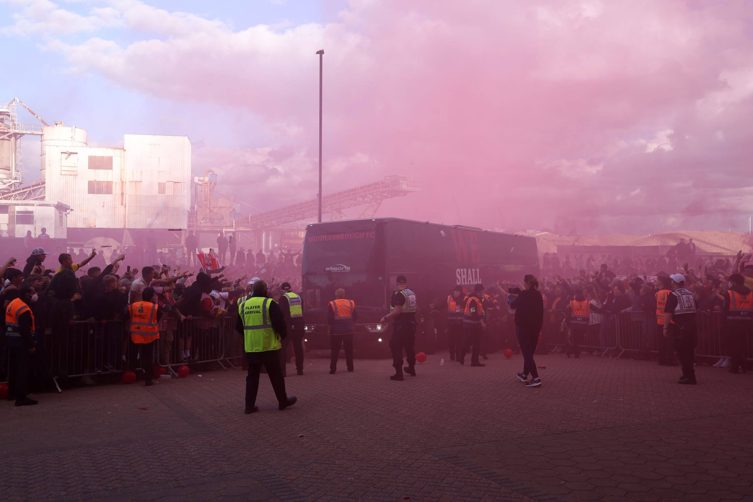 The Middlesbrough team coach arrives at St Mary's as fans are seen letting off flares and gesturing