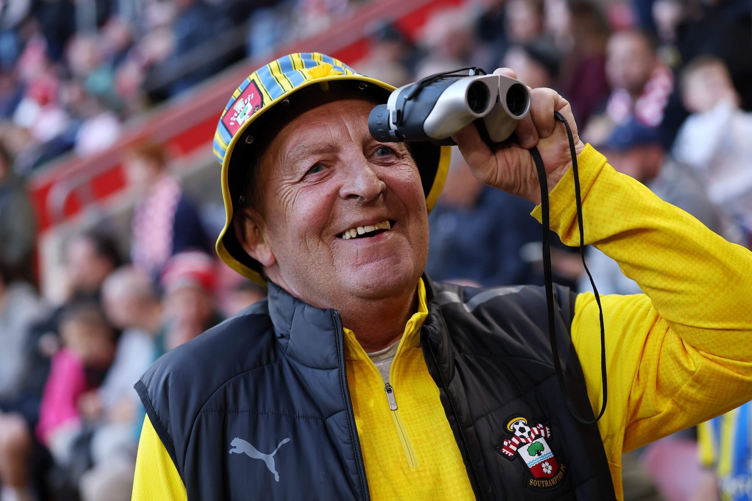 A Southampton fan is seen using binoculars inside the stadium prior to kick off in the Championship play-off semi-final