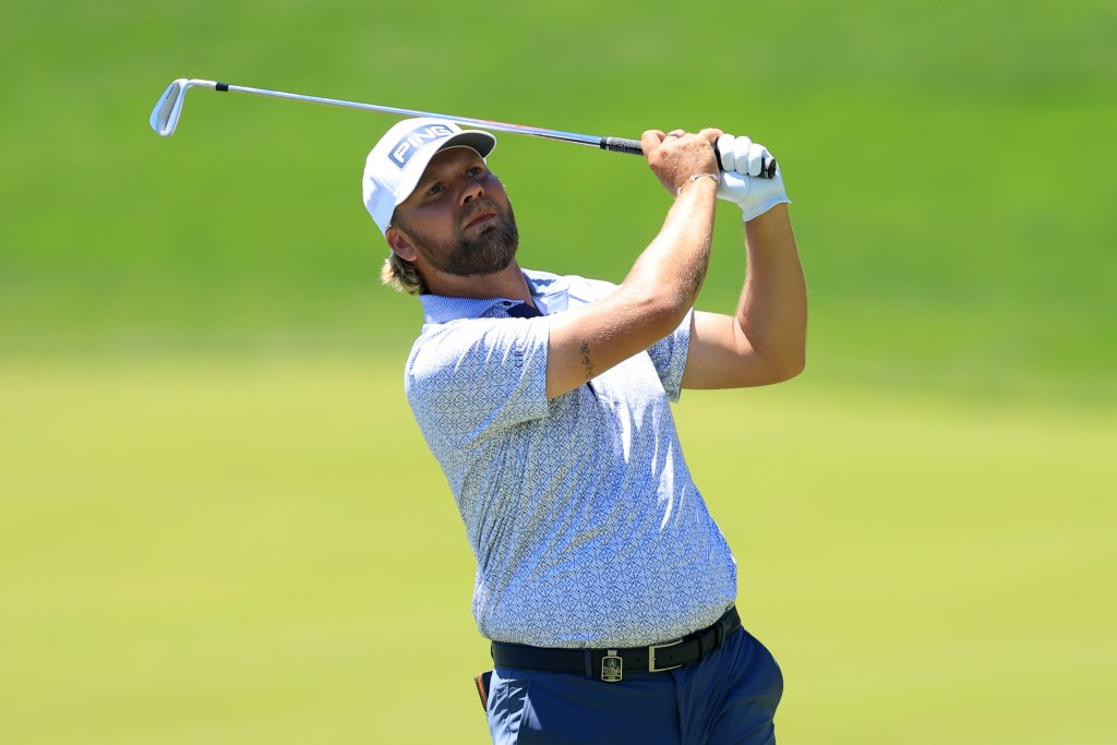 Daniel Brown of England hits his second shot on the 18th hole during the third round of the PGA Championship at Aronimink Golf Club on May 16, 2026 in Newtown, Pennsylvania.