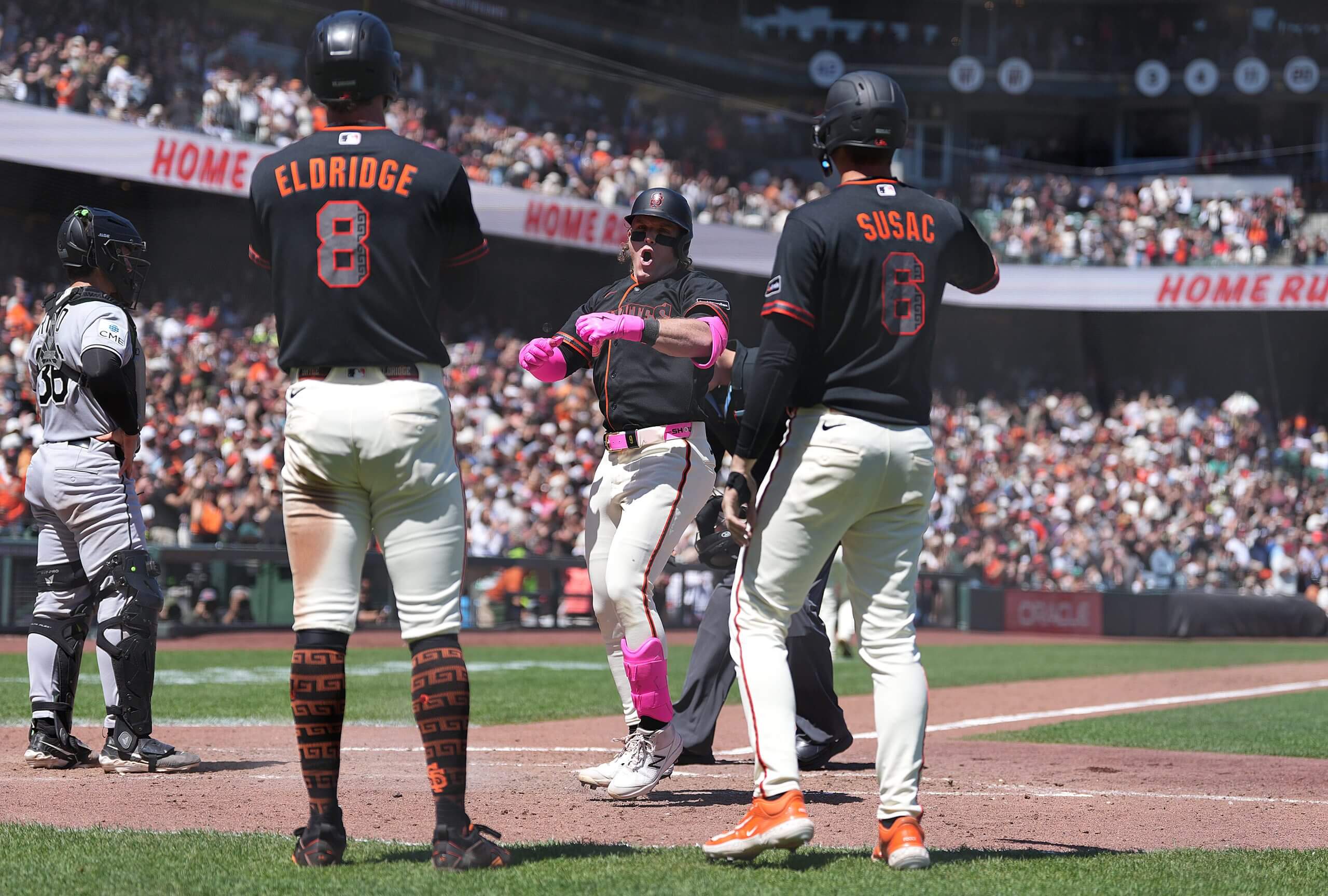 Harrison Bader, with pink batting gloves, celebrates after a grand slam.