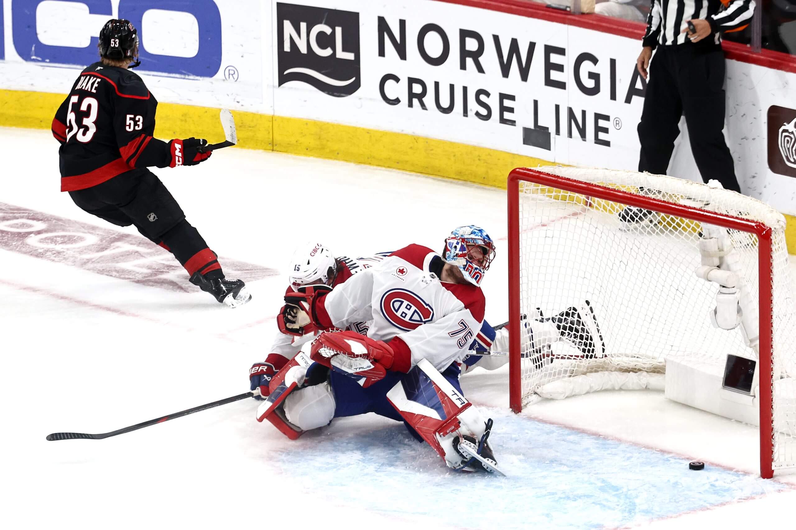 Jackson Blake, left, of the Carolina Hurricanes scores a goal past Jakub Dobeš of the Montréal Canadiens.