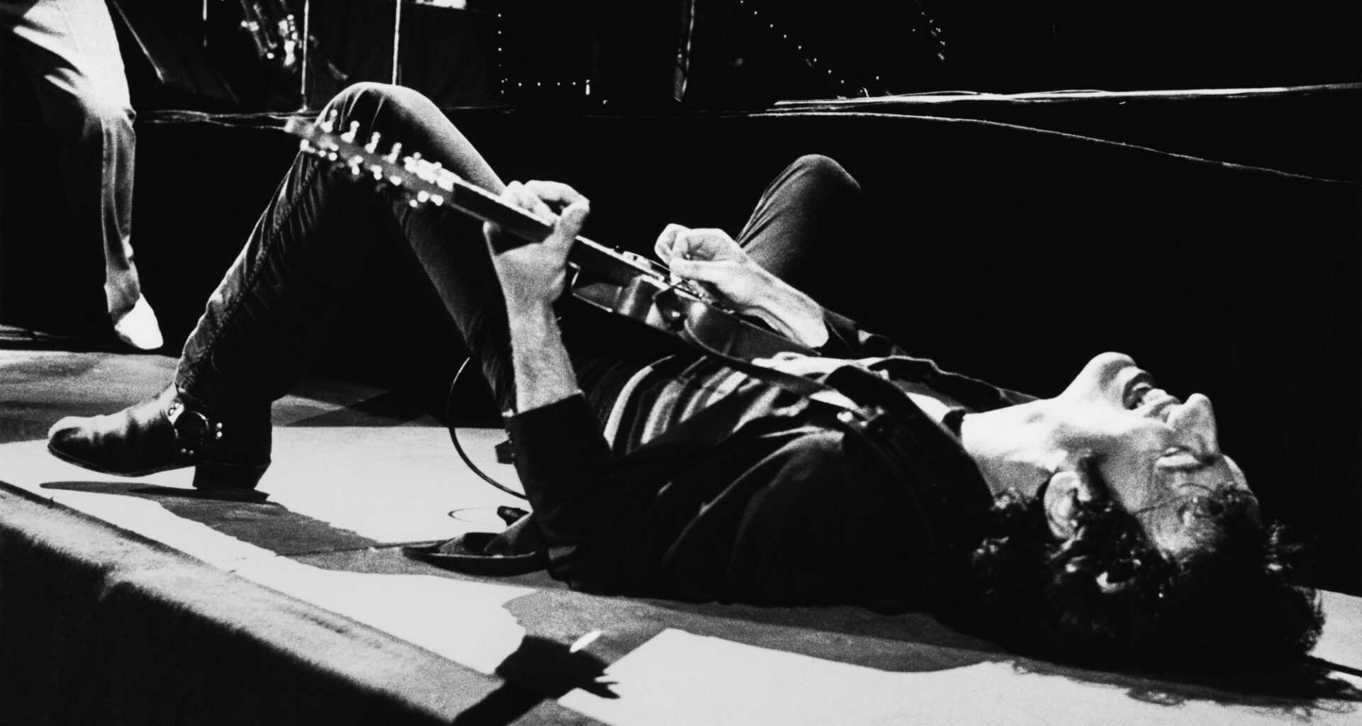 LOS ANGELES, CA - July 5: Rock and roll icon Bruce Springsteen falls to the stage and continues playing the guitar on his back on July 5, 1978 at the Forum in Inglewood, California. (Photo by George Rose/Getty Images)