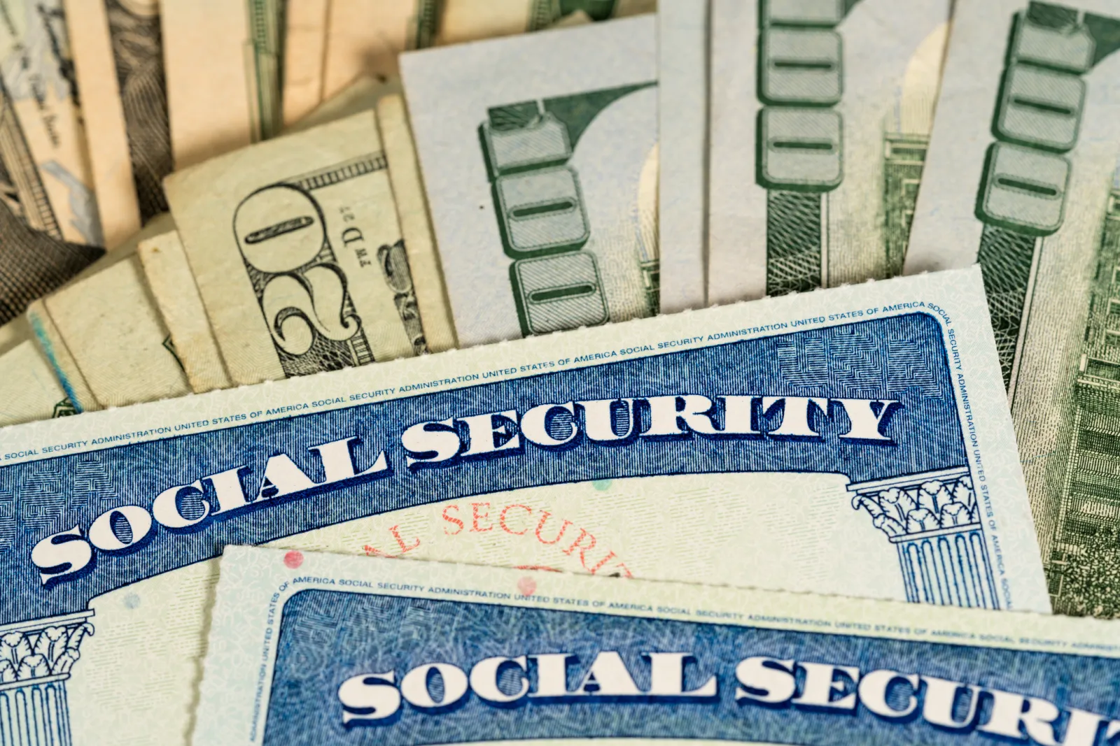 Stock image/file photo: Social Security card with U.S. dollar bills.