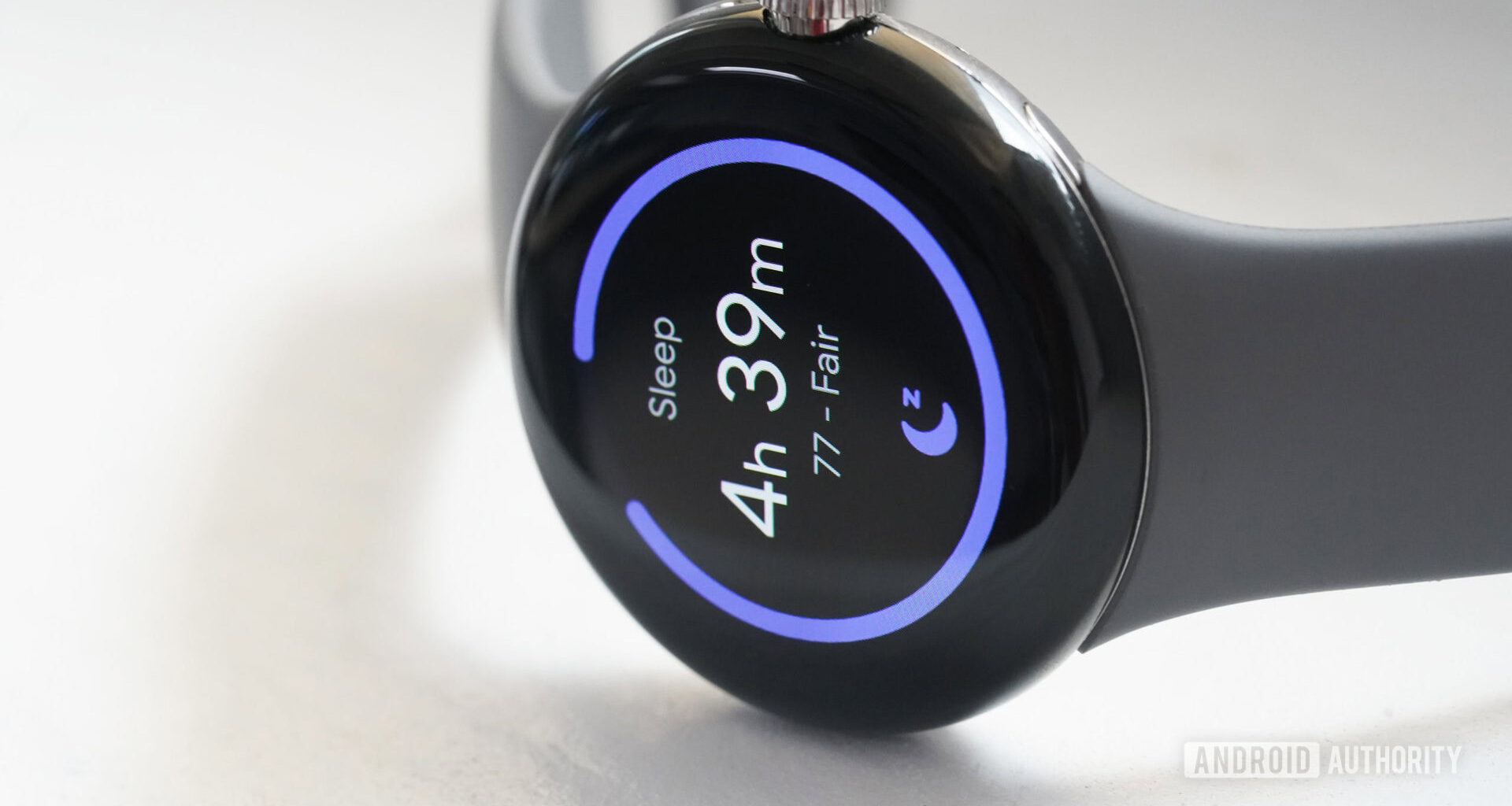 A Google Pixel Watch rests on its side displaying a user's sleep score.