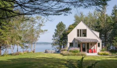 Red posts at the entry are an ode to the homeowner’s mom and also reference the red tinge of new Eastern white-cedar planks that have been stained gray, replacing the previous brown clapboard siding.
