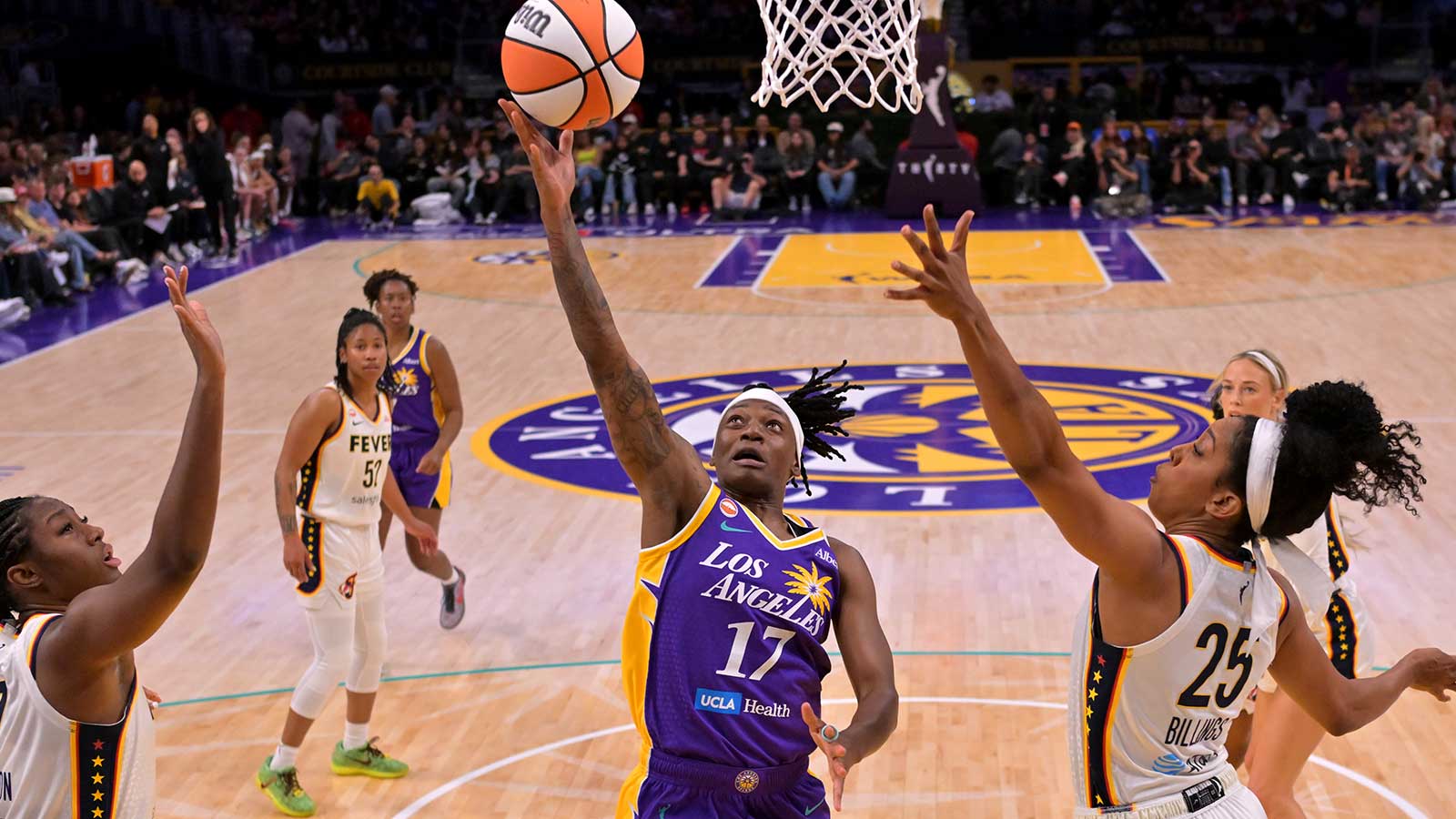 Los Angeles Sparks guard Erica Wheeler (17) drives past Indiana Fever center Aliyah Boston (7) and forward Monique Billings (25) in the first half at Crypto.com Arena.