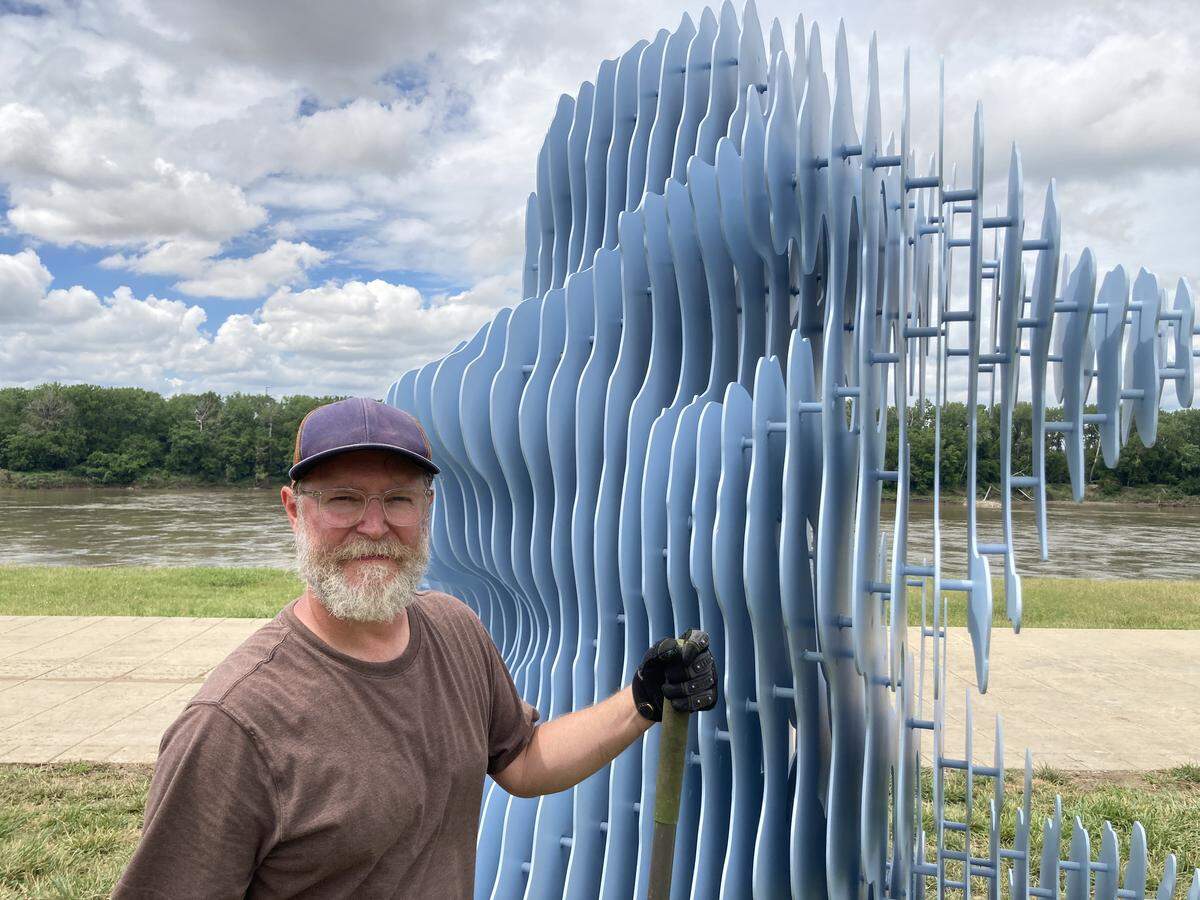 Artist Ben Butler of Memphis, Tennessee stands alongside his sculpture, “Rivercloud,” shortly after installation at Berkley Riverfront Park on Friday, May 29, 2026.