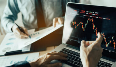 Investors are pointing to laptops that have investment information stock markets and partners taking notes and analyzing performance data