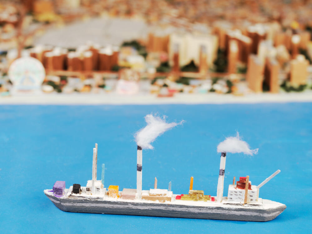 A ship made of balsa wood and cardboard, complete with a smokestack blowing "cotton" smoke. (Joe Macken/Museum of the City of New York)