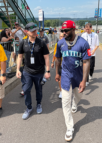 Javier Román M ’14 (left) walks with the Seattle Mariners' Randy Arozarena at the Little League Classic in Williamsport, Pennsylvania.