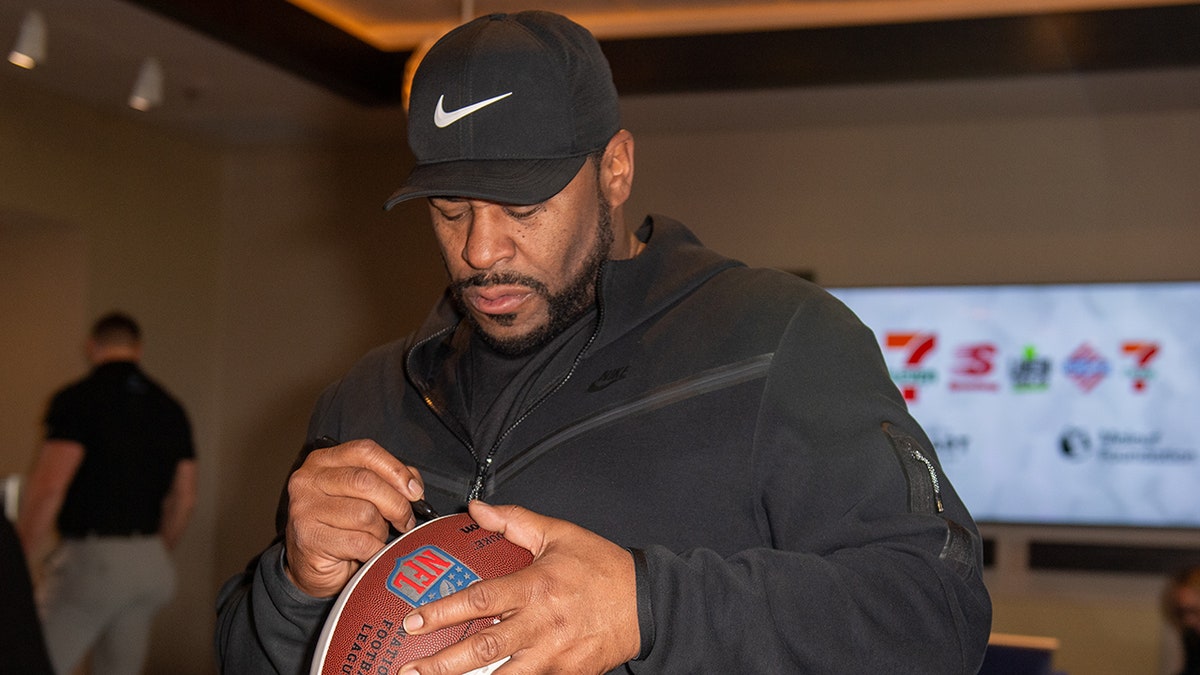 Jerome Bettis signing a football at Topgolf Las Vegas