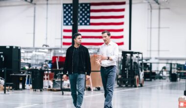 Chairman John Jovanovic walking one factory floor with Karan Kunjur