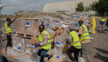Workers offload medical and emergency supplies donated by the European Union to support frontline workers at the national airport in Bunia, Congo.