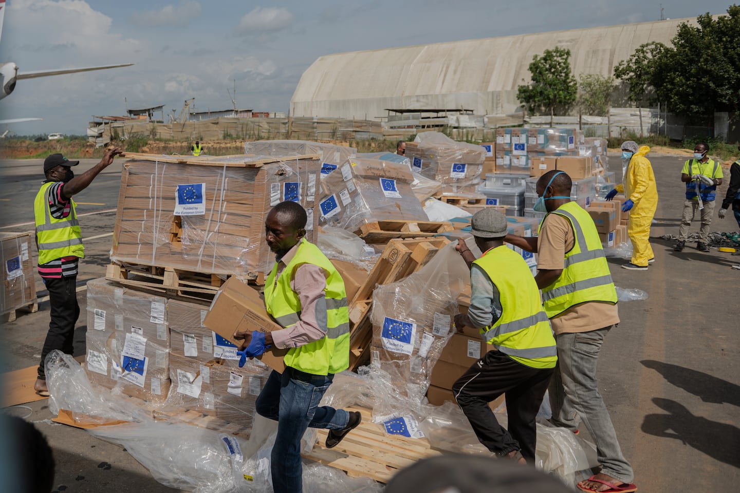 Workers offload medical and emergency supplies donated by the European Union to support frontline workers at the national airport in Bunia, Congo.