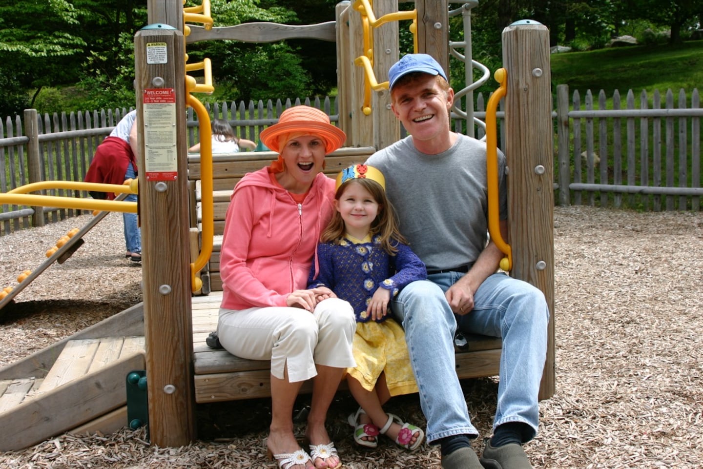 An undated photo of Jessica Reilly, center, with her parents, Kathy and Dennis. Reilly, now 24, underwent genetic testing to determine her cancer risk after both of her parents had cancer.