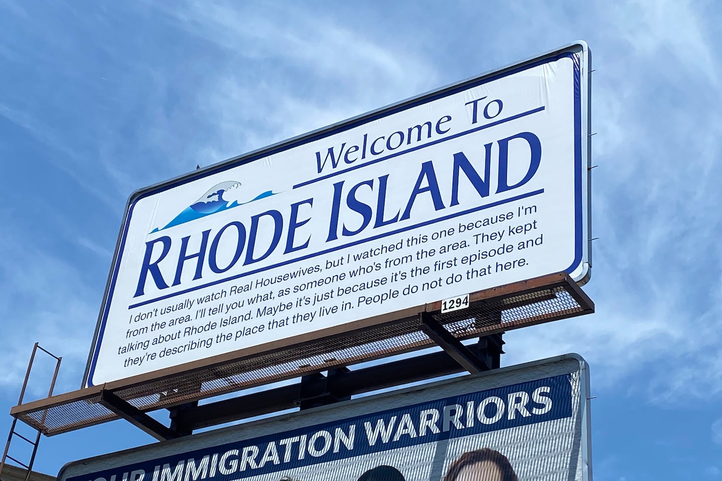 A "Welcome to Rhode Island" billboard featuring a Reddit comment about "The Real Housewives of Rhode Island" in downtown Providence is the work of Darian Newman, a graduate student at the Rhode Island School of Design.