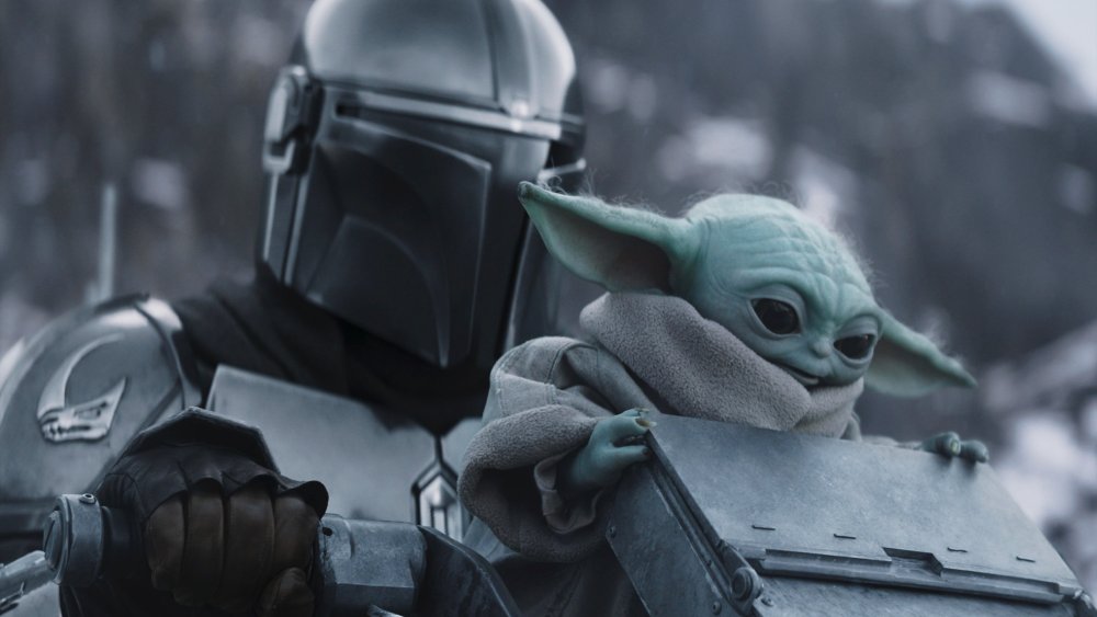 STAR WARS: THE MANDALORIAN AND GROGU, from left: Pedro Pascal as The Mandalorian / Din Djarin, Grogu, 2026. © Walt Disney Studios Motion Pictures / Courtesy Everett Collection