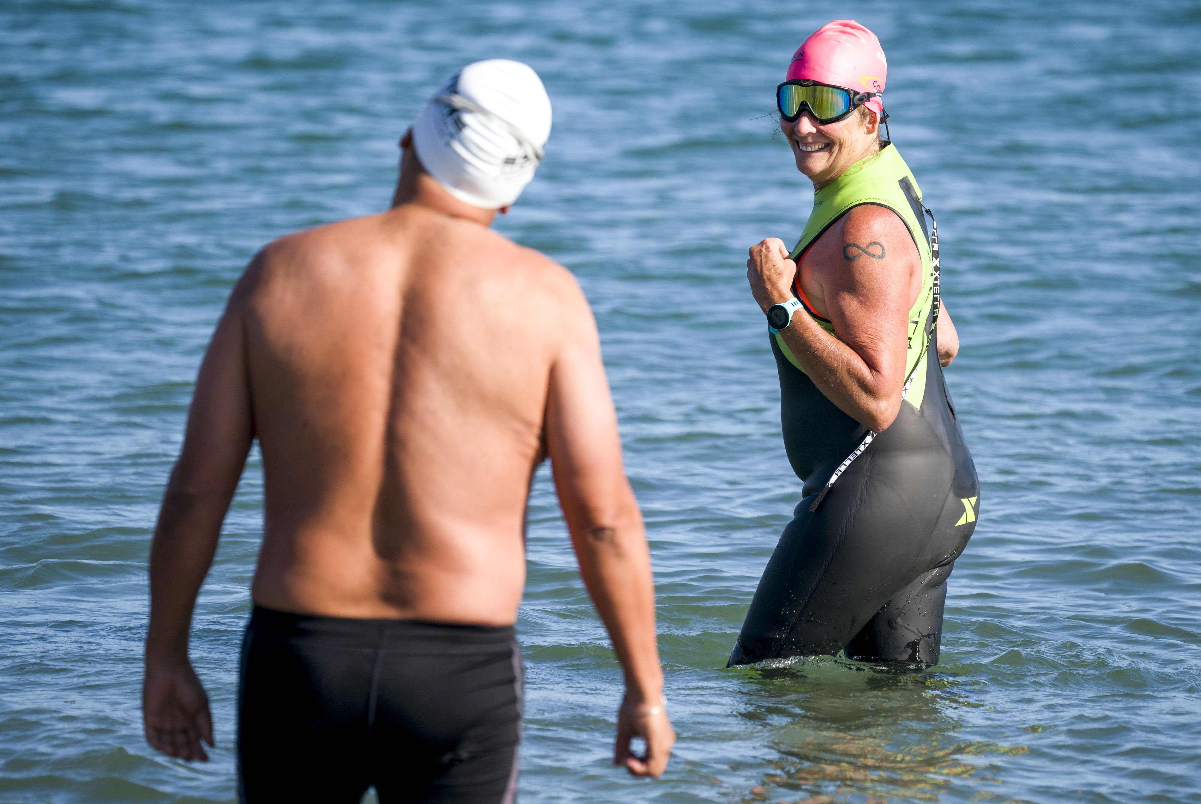 Maria Korcsmaros, right, looks back to fellow shark attack survivor,...