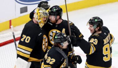 Boston Bruins goaltender Joonas Korpisalo (70) with centers Elias Lindholm (28), Marat Khusnutdinov (92) and Fraser Minten (93) celebrate after their team's win over the Pittsburgh Penguins in an NHL hockey game Sunday, Jan. 11, 2026, in Boston.