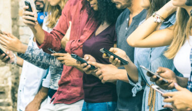 people looking at phones