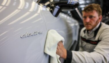A Porsche employee checks an all-electric Porsche Macan in quality control at the Leipzig plant.