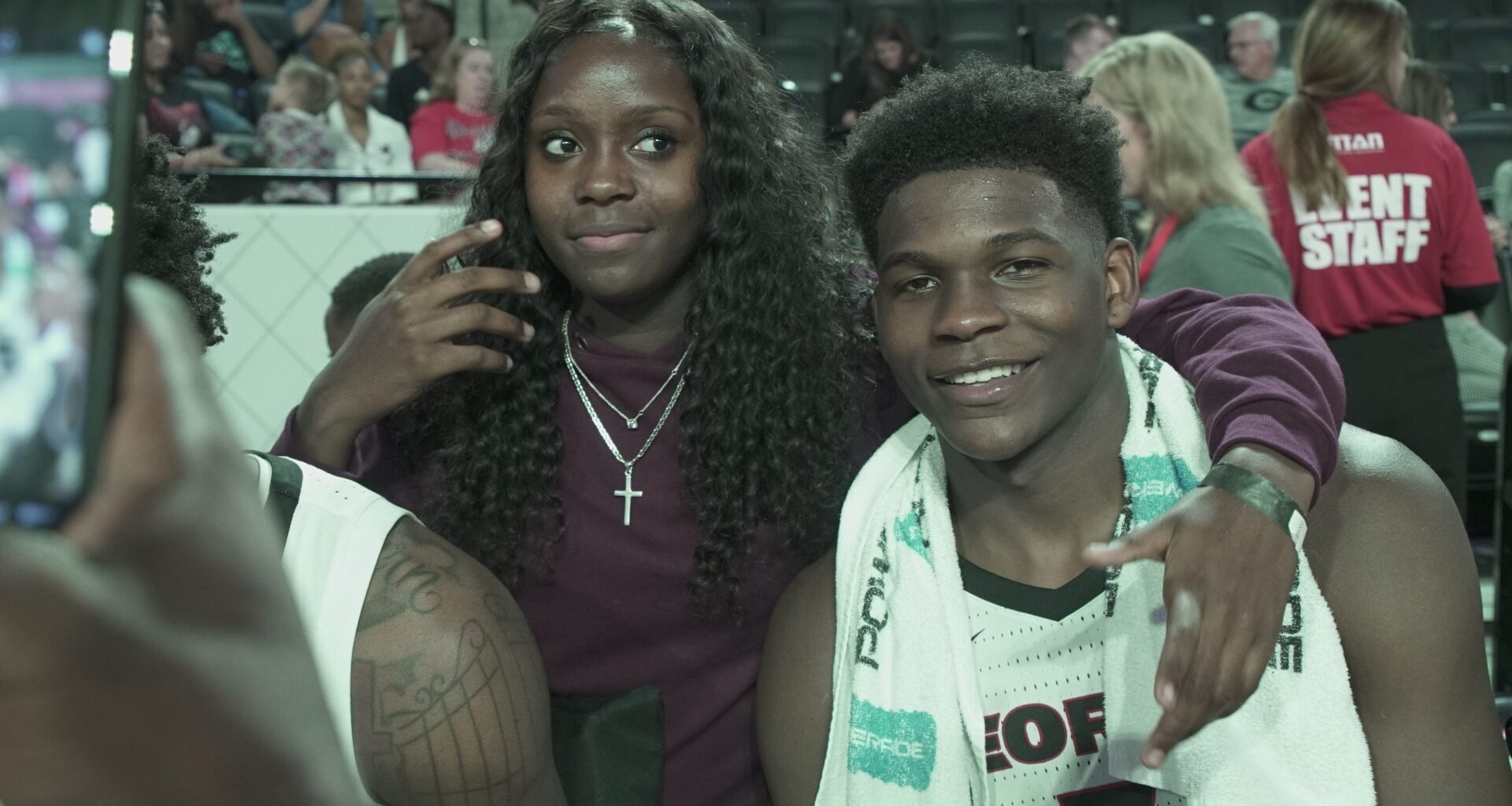Raven Johnson (left) and Anthony Edwards (right) take photos after one of his games at the University of Georgia in 2019.