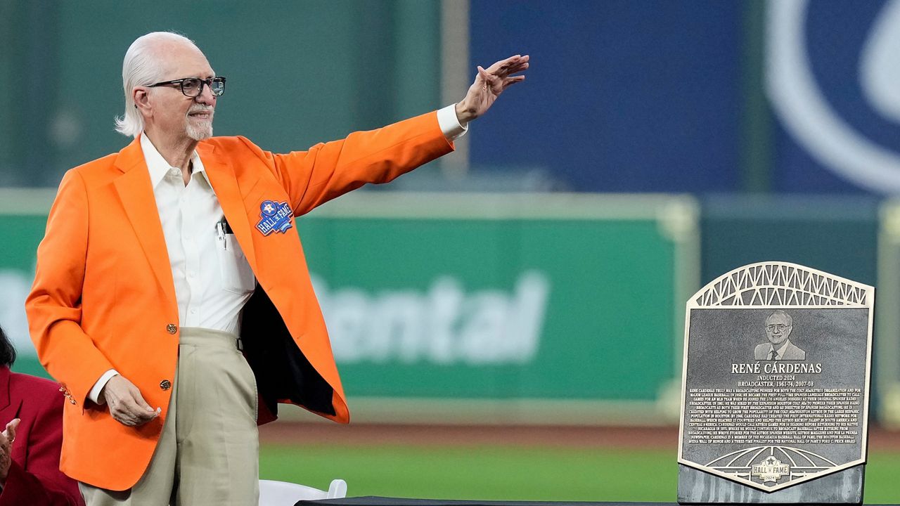 Longtime Spanish radio broadcaster René Cárdenas waves to the crowd as he is inducted into the Houston Astros Hall of Fame Saturday, Aug. 17, 2024, in Houston. (AP Photo/Kevin M. Cox, File)