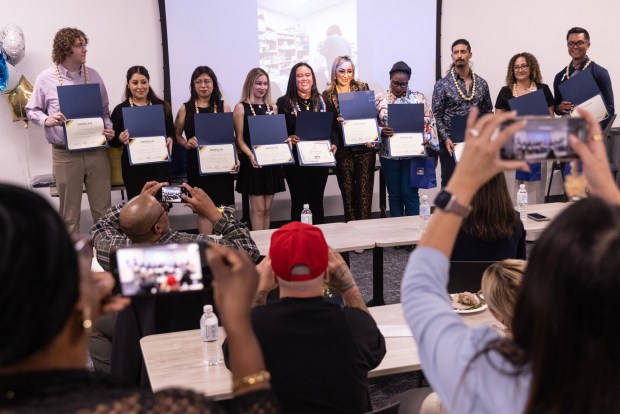 San Diego, CA - Friends a family members take photos during a graduation ceremony for ten new sterile processing technicians who formerly worked in food and environmental services at UC San Diego Health on Tuesday, May 26, 2026, in San Diego, CA. (Luke Johnson / The San Diego Union-Tribune)