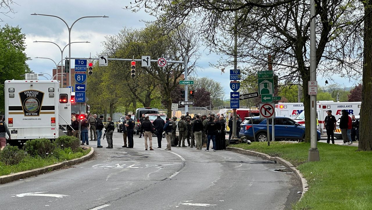 Police respond to the scene where two officers were shot and another injured Saturday. (Spectrum News 1/Krystal Cole)