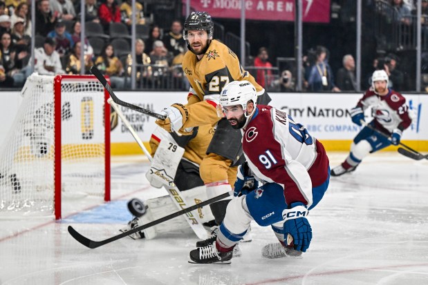 Nazem Kadri (91) of the Colorado Avalanche and Shea Theodore (27) of the Vegas Golden Knights track the puck as it squirts loose during the third period of the Golden Knights' 5-3 win in Game 3 of the NHL Western Conference Final at T-Mobile Arena in Las Vegas, Nevada on Sunday, May 24, 2026. Las Vegas now leads the series 3-0. (Photo by AAron Ontiveroz/The Denver Post)