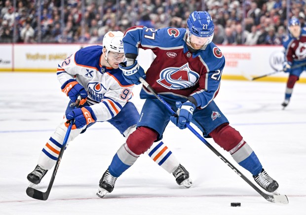 Brett Kulak (27) of the Colorado Avalanche handles the puck as Vasily Podkolzin (92) of the Edmonton Oilers defends during the third period of the Oilers' 4-3 win at Ball Arena on Tuesday, March 10, 2026. (Photo by AAron Ontiveroz/The Denver Post)