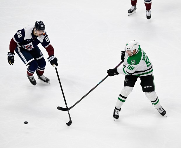 Dallas Stars right wing Mikko Rantanen (96) sends the puck down ice against Colorado Avalanche center Martin Necas (88) in the second period at Ball Arena in Denver on Sunday, March 16, 2025. (Photo by Andy Cross/The Denver Post)