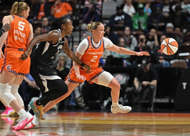 Haley Van Lith #2 of the Connecticut Sun and Jewell Loyd #24 of the Las Vegas Aces chase a loose ball in the first half at Mohegan Sun Arena on May 13, 2026 in Uncasville. (Sean D. Elliot/Getty Images)