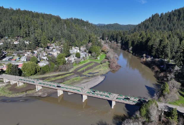 The Russian River flows through Monte Rio, at the Monte Rio Bridge, on Friday, January 9, 2026. Untreated wastewater, including sewage, overflowed for three days starting Jan. 6 into the Russian River from the treatment plant operated by Sonoma Water on Neeley Road, near Guerneville. (Christopher Chung/The Press Democrat)