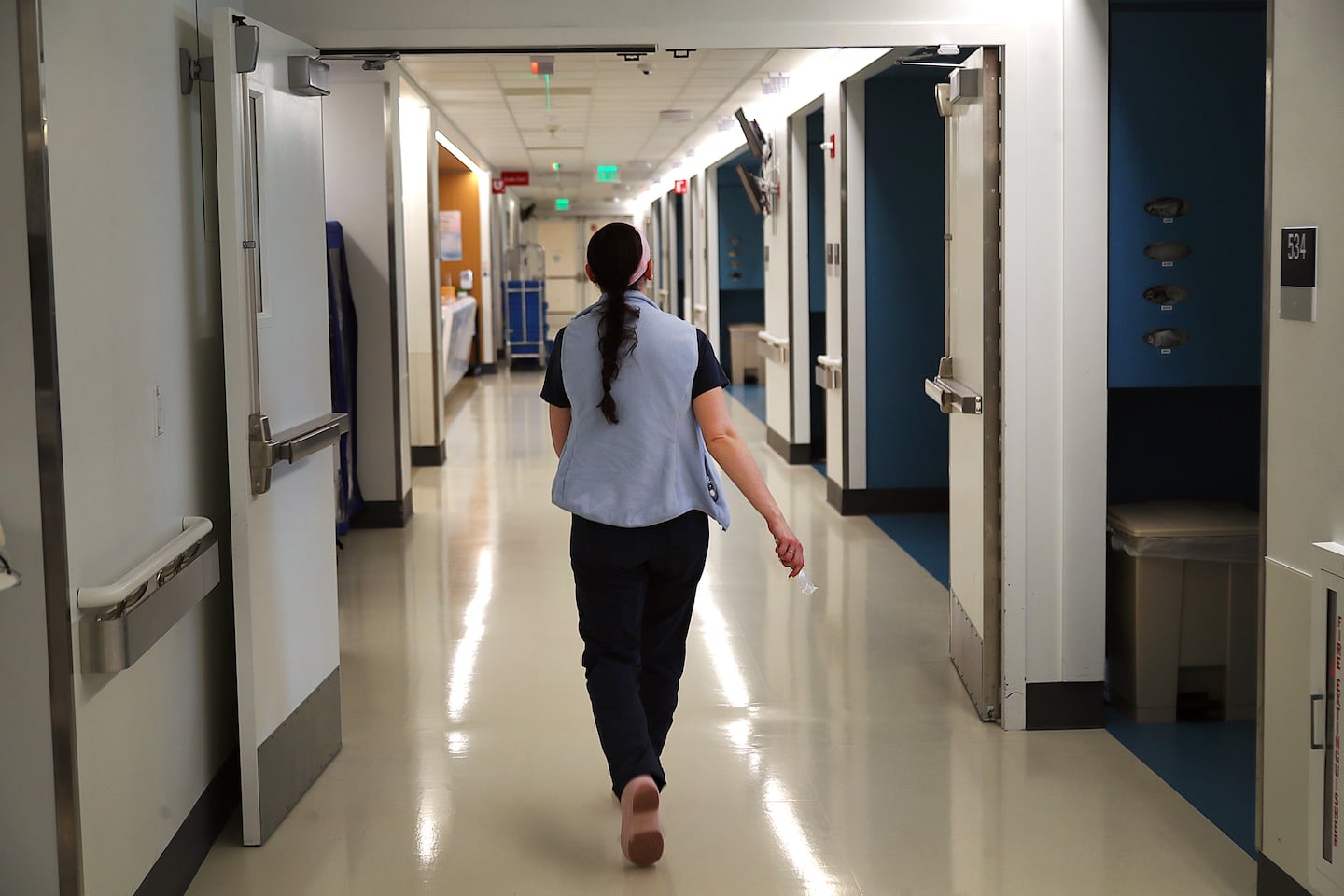 A nurse walked through a hallway at Mass General Brigham’s Newton-Wellesley Hospital in May.