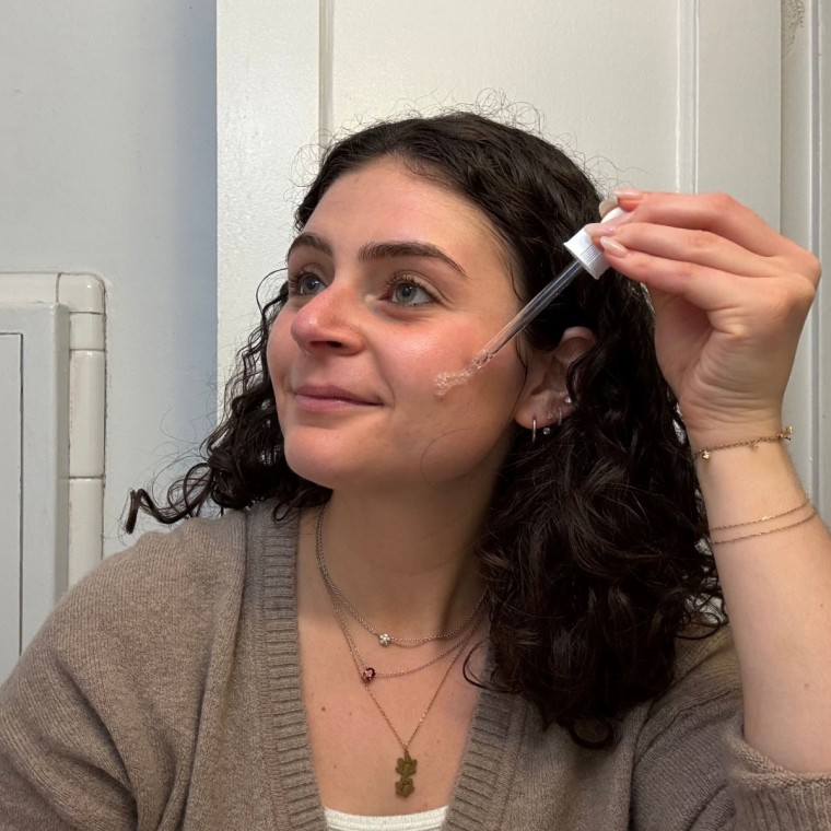 A woman applying The Ordinary’s Hyaluronic Acid 2% + B5.
