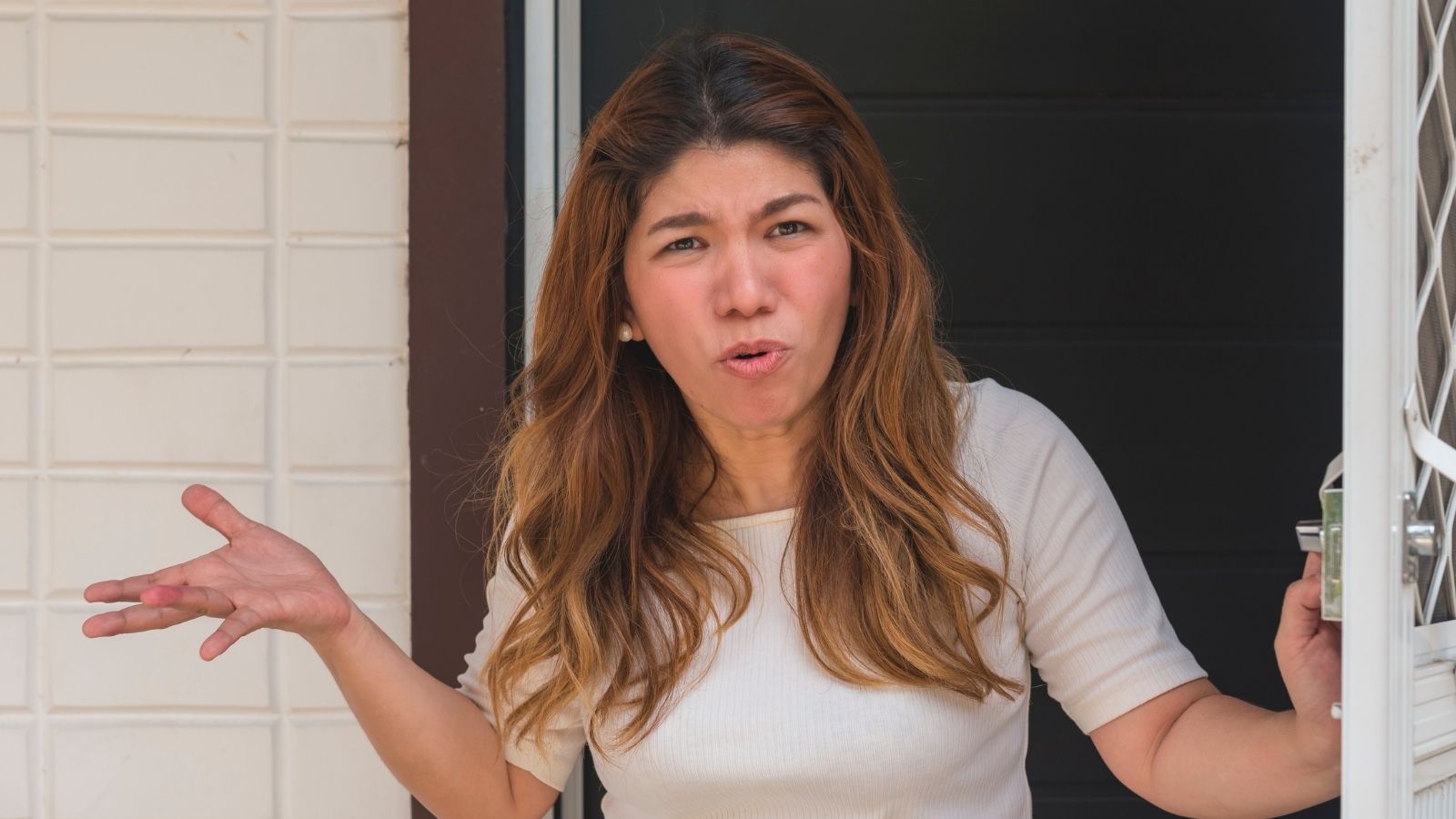 upset woman opening her front door