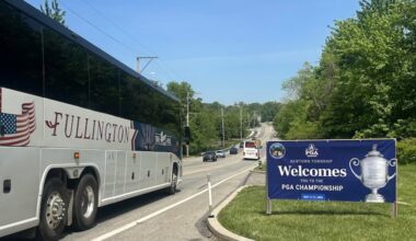 A sign welcomes the PGA Championship to Newtown Township as buses shuttle spectators down State Route 252 to Aronimink Golf Club.