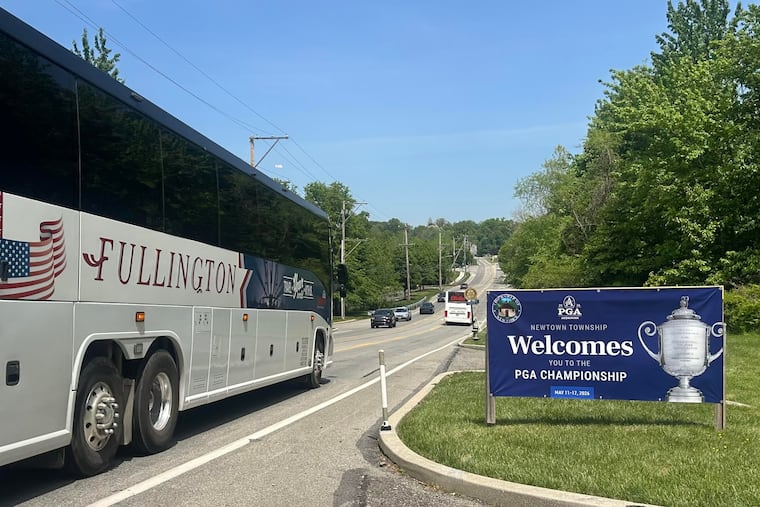 A sign welcomes the PGA Championship to Newtown Township as buses shuttle spectators down State Route 252 to Aronimink Golf Club.