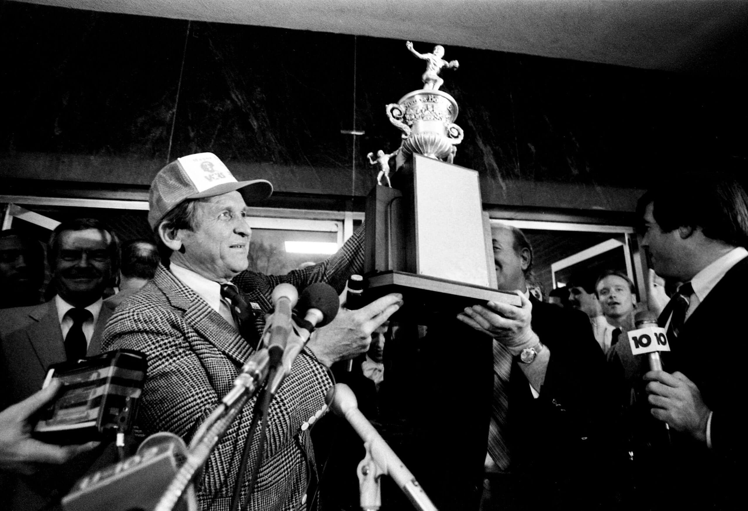 Johnny Majors holds up the 1986 Sugar Bowl trophy.