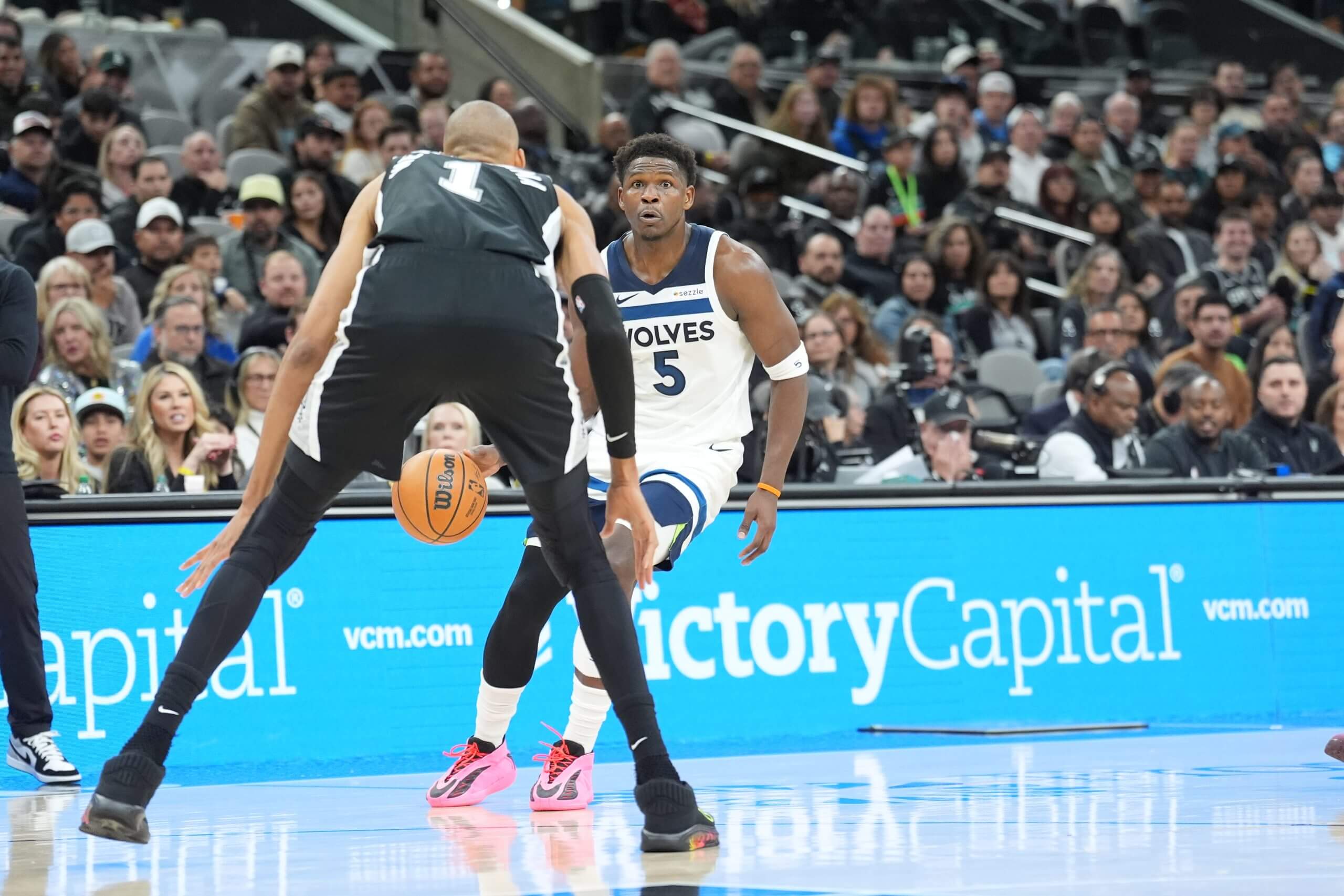 Minnesota Timberwolves guard Anthony Edwards dribbles in front of San Antonio Spurs forward Victor Wembanyama