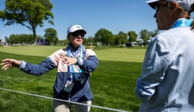 Villanova's Courtney Obregon, one of the many PGA Championship volunteers from the area, teaches Kathy Leidheiser, of Glen Mills, what to look out for as a marshal on the 18th hole at Aronimink.