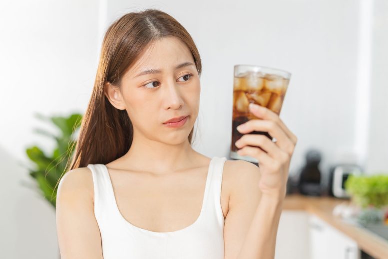 Woman Holding Glass of Diet Soda