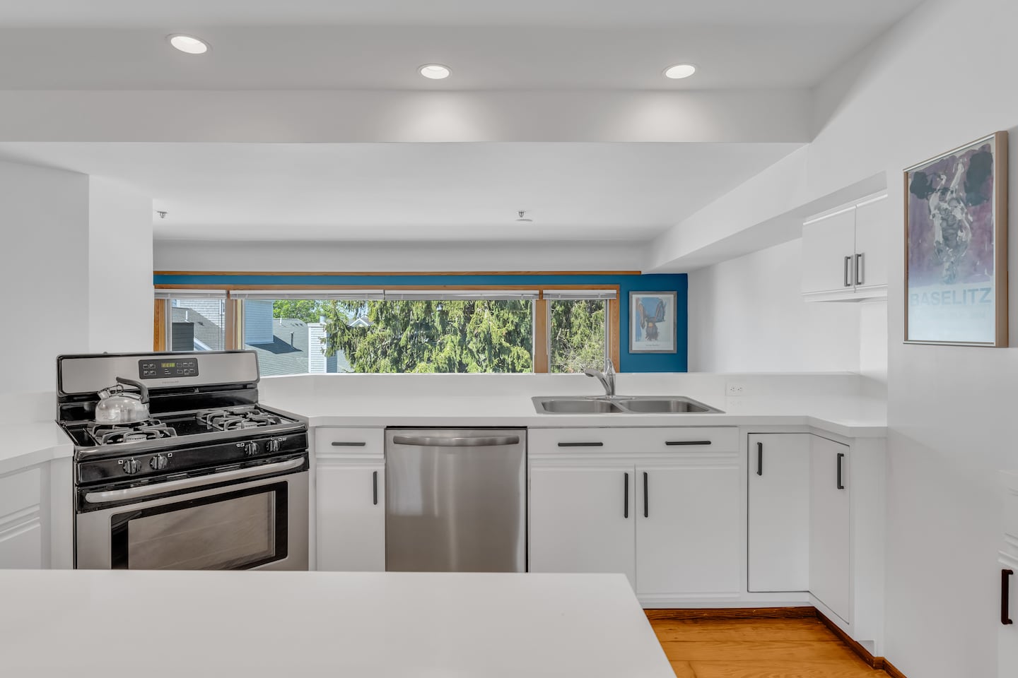 The kitchen looks over the living room.