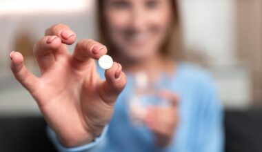 Young Woman Hand Holding White Pill Smiling
